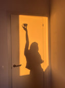 woman practicing morning ritual with journal and tea in soft morning light