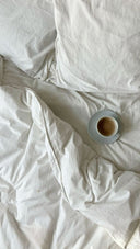 woman's bedside evening ritual with chamomile tea for natural sleep support